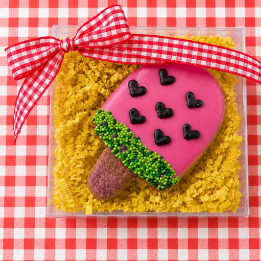 a gift box with one watermelon pupsicle and red gingham bow