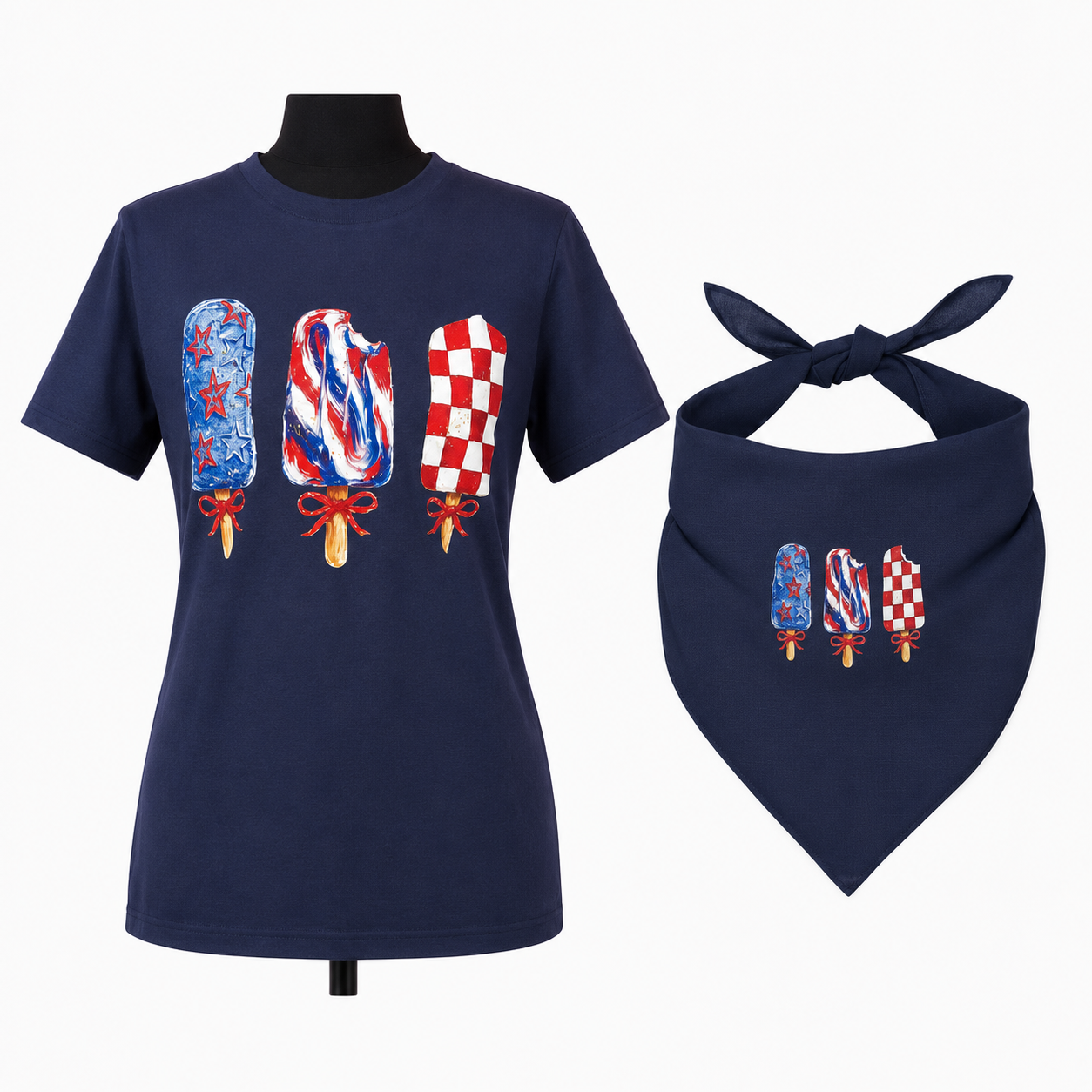 A navy blue short-sleeve t-shirt and matching bandana set displayed on a mannequin and stand. The front of both items features three popsicle graphics in a red, white, and blue patriotic theme.