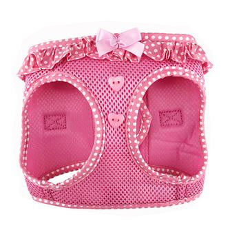 Pink pet harness with polka dots and a bow on a white background