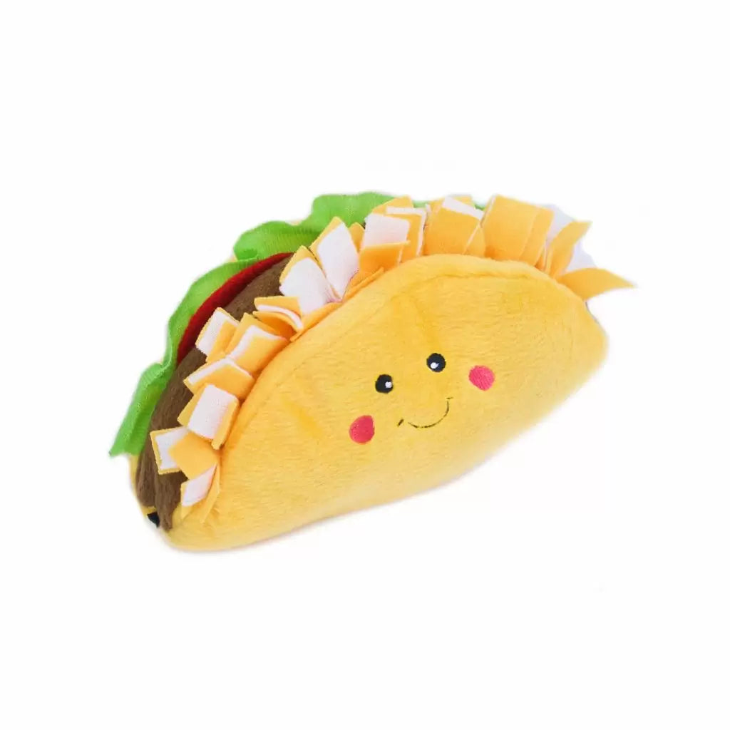 Plush taco toy with a smiling face on a white background